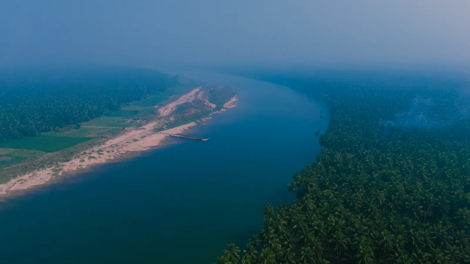 Aerial view of the Godavari winding past a sandbank through the green Konaseema delta